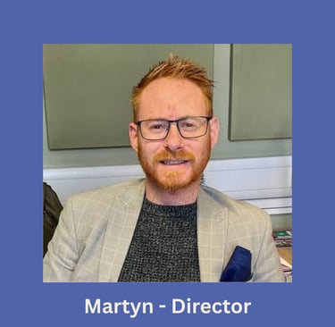 Portrait of Martyn, company director, smiling in an office setting.