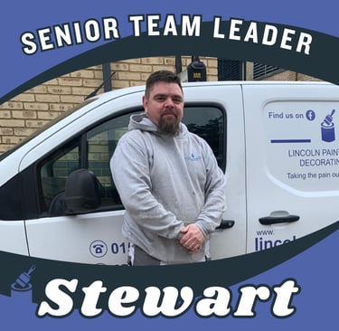 Portrait of Stewart, a senior team leader, smiling and standing next to his branded van.