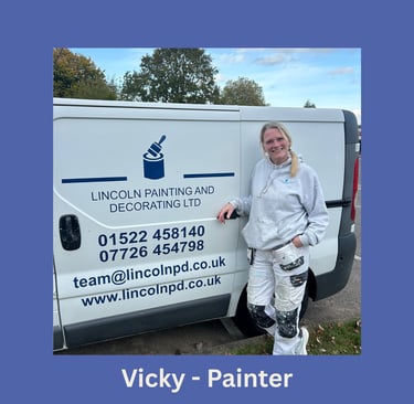 Portrait of Vicky, an LPAD painter, smiling and standing next to her branded van.