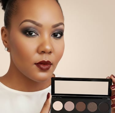 Woman with smokey eye makeup and dark lipstick holding a neutral eyeshadow palette.
