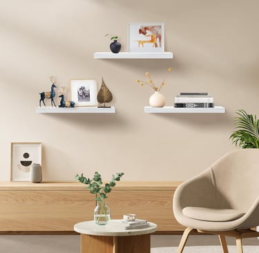 White floating shelves displaying plants, books, and modern home decor accessories