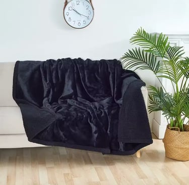 Soft plush throw on chair in cozy small bedroom corner