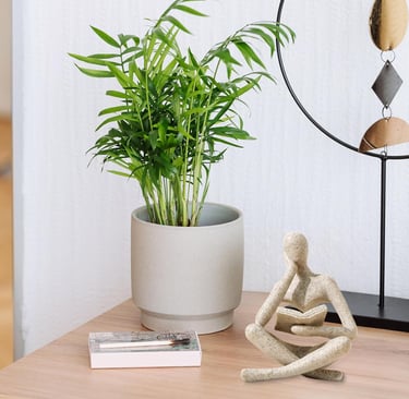 Thinker Statue styled with books and indoor plants on a small table for cozy home decor