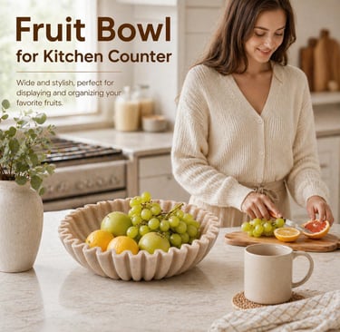A fluted marble fruit bowl for kitchen counter organization, shown with fresh grapes and citrus.