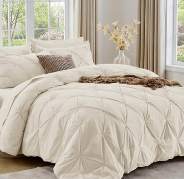 Sasttie 7-piece beige pinch pleat comforter set styled in a bright modern bedroom with neutral decor.