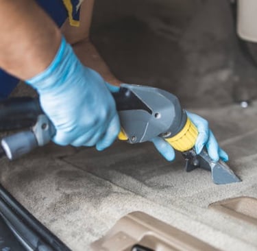 a man in blue gloves and gloves is using a cordless tool