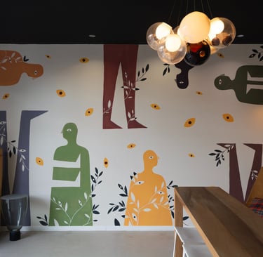 a wall mural of a woman sitting on a bench