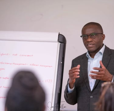 Business professional leading a corporate workshop on performance management and hybrid work styles.