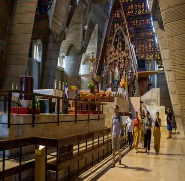 Tourists walking through the modern interior of Basilica of Our Lady of Altagracia in Higuey.