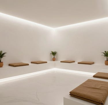 Relaxing lounge area bathed in soft light with dark sleek furniture and neon blue highlights.