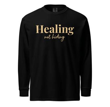 Black long-sleeve shirt featuring gold text that reads Healing not hiding for mental health awareness.
