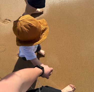 Founder of Soft Strength Mother walking on the beach holding hands with her son