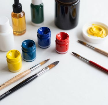 An artist’s workspace featuring sketchbooks, pencils, and watercolor palettes.