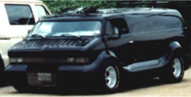 a creepy black van parked in a parking lot