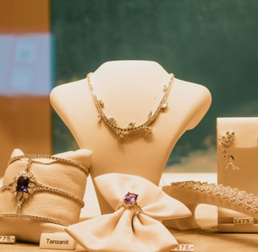 Luxury tanzanite and diamond jewelry set featuring a necklace, ring, and bracelet on display.