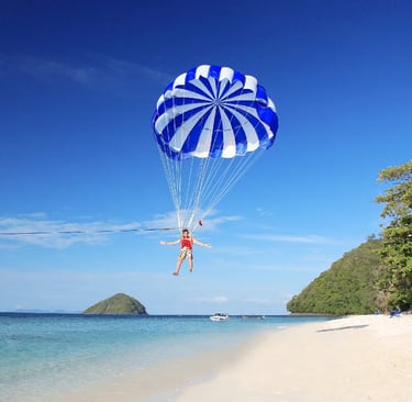 Parasailing adventure at Pattaya beach with clear blue sea and tropical islands