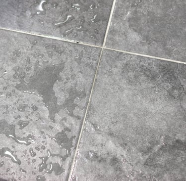 Bathroom stone surface in wet and dry tonal shift, French Mediterranean.