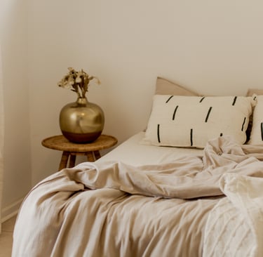 Linen and plaster carrying color in a French Mediterranean bedroom.