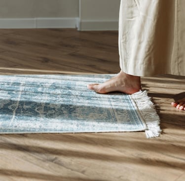 Wood floor beside the bed in a French Mediterranean bedroom.