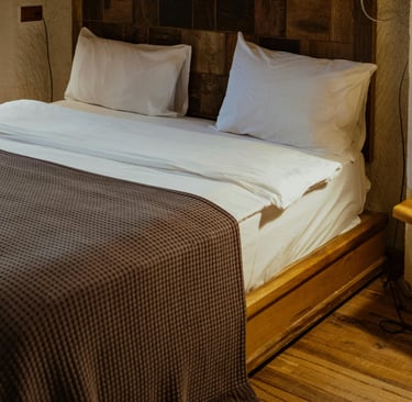 Wood and plaster meeting in a French Mediterranean bedroom.