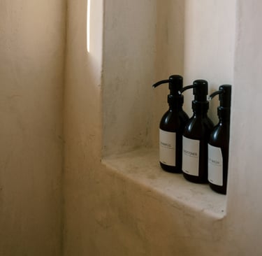Tadelakt wall meeting stone floor in a Mediterranean bathroom.
