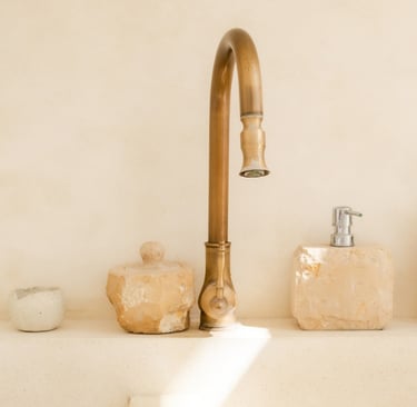 Brass tap on a stone basin in a Mediterranean bathroom.