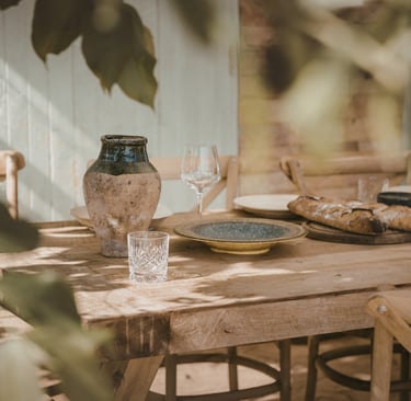 Steady southern light across a dining table in a French Mediterranean room.