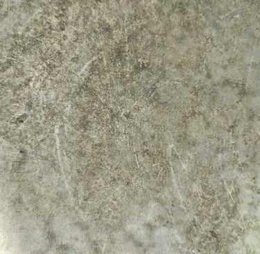 Honed stone kitchen worktop with soft veining and natural patina.