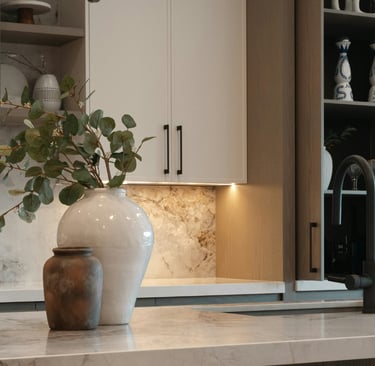 Soft task light across a kitchen counter in a French Mediterranean kitchen.