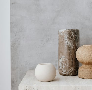 Warm tonal palette in a French Mediterranean living room —earthty tones against stone