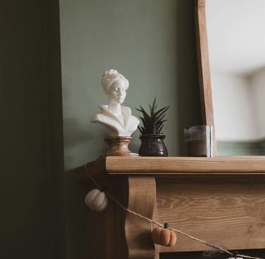 Muted olive and warm wood in a French Mediterranean living room.