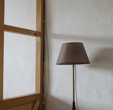 Detail of natural materials in a Mediterranean interior — plaster, linen, and wood in warm neutral t