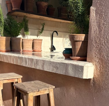 Warm stone and limewashed wall on a French Mediterranean terrace.