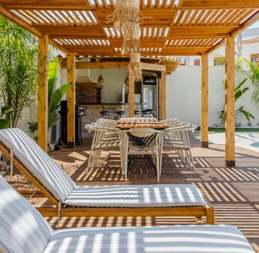 A French Mediterranean terrace table set against a protected edge at the hour it is used.
