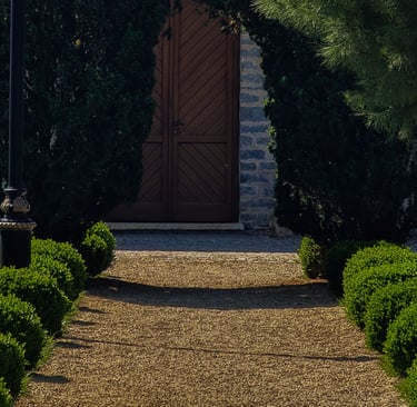 Gravel meeting stone edge on a French Mediterranean terrace.