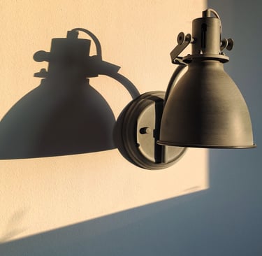 The same warm white wall shown in warm afternoon light and shadow.