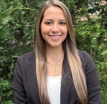 a woman in a black jacket and white shirt named claudia cardona