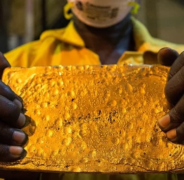a man in a yellow jacket holding a piece of gold