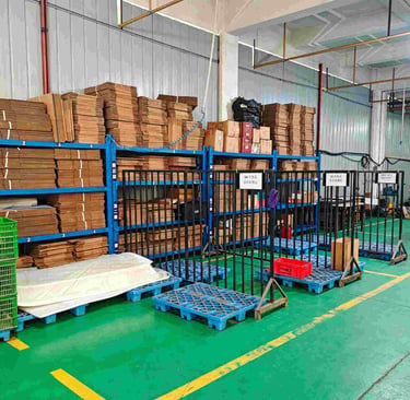 Organized warehouse storage with stacked cardboard boxes on blue shelving units and plastic pallets.