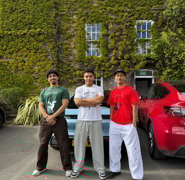 three break dancers stood outside an old building covered in ivy