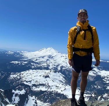 Noah Phillips standing on top of a mountain in Washington