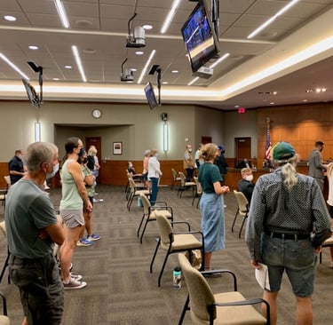 Photo of people standing in support of an item at city council