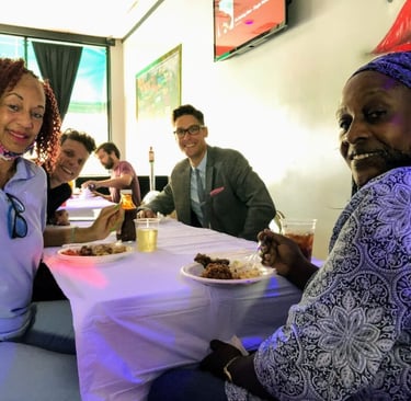 Four people in meeting around a table, smiling at the camera