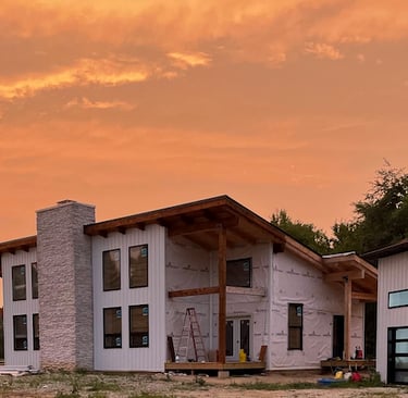 white timberframe home at sunset