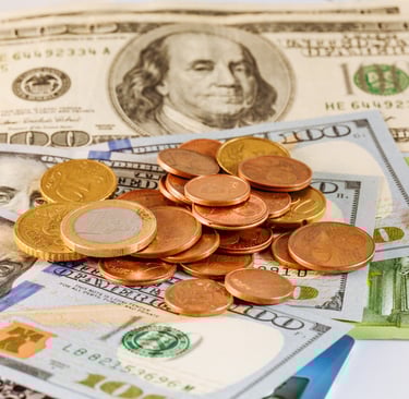 US dollars and euro coins on a table with money tips for traveling to the Dominican Republic