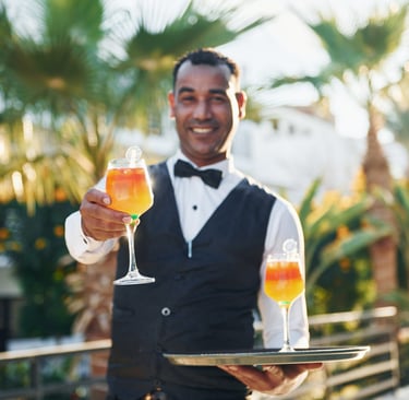 Friendly resort staff serving cocktail at Dominican Republic all-inclusive