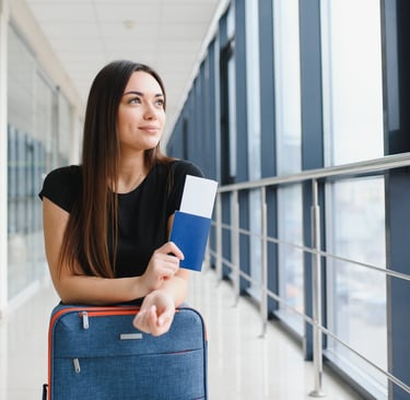 a woman holding a passport, airline ticket and dominican eticket