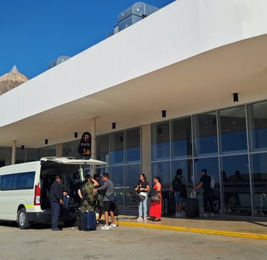Airport transfer shuttle at Punta Cana International Airport in the Dominican Republic with travelers and luggage.