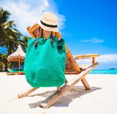 Beach chair with towel and beach bag at a tropical resort beach in the Dominican Republic