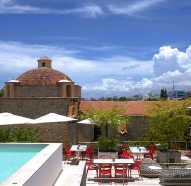 Rooftop pool in Santo Domingo Colonial Zone with historic church and city view